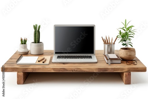 A wooden desk with a closed laptop, notebook, and potted plant isolated on white