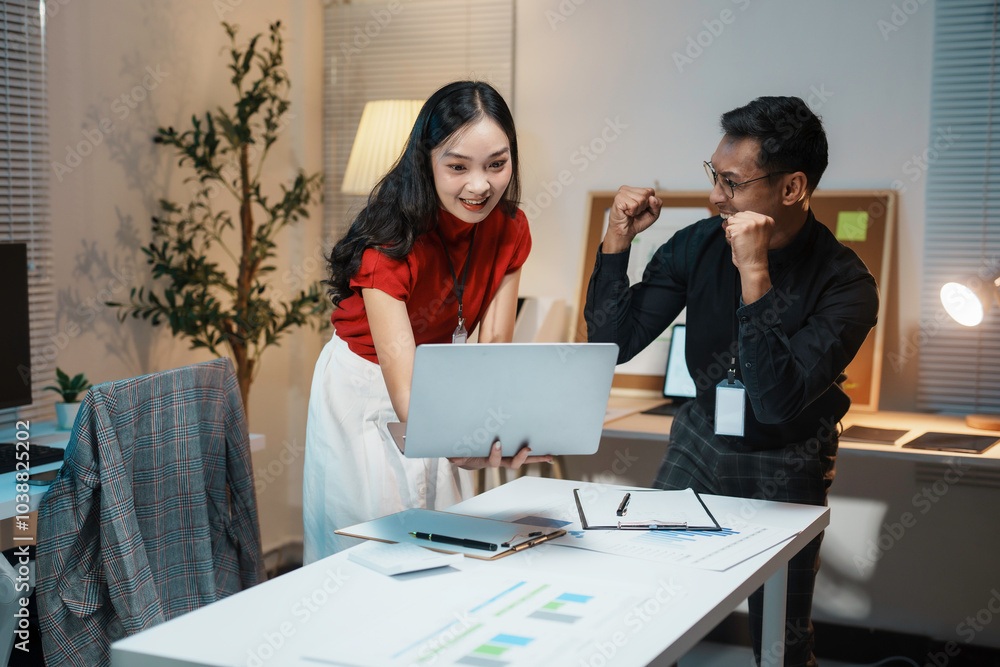 Business partners feeling happy about positive results shown on a laptop, celebrating success and new achievements Business partners feeling happy about positive results shown on a laptop, celebrating success and new achievements