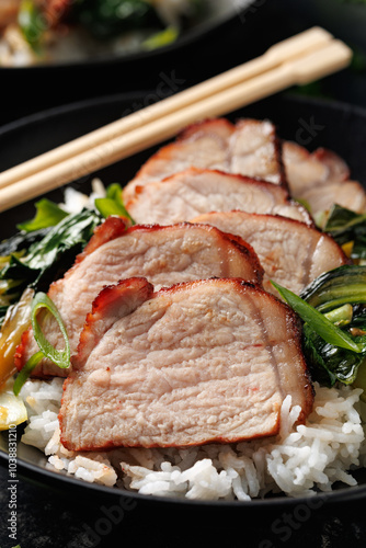 Chinese BBQ Pork Char Siu with rice and bok choy in a black bowl photo