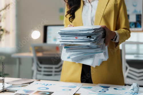 Stressed businesswoman in a busy office with a huge stack of paperwork, showing the challenges of managing documents in a corporate setting