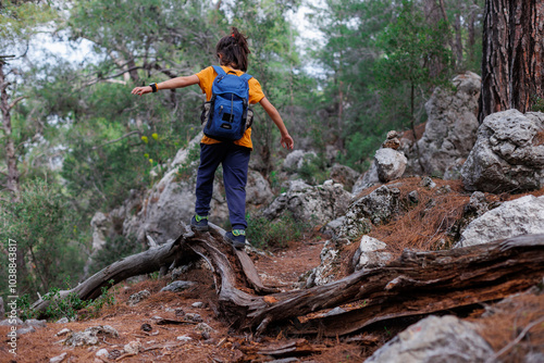 summer camp. happy boy with a backpack explores the summer forest. trekking and hiking.