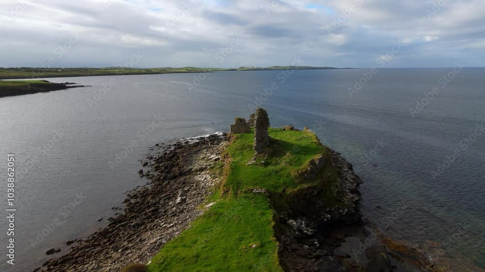 St John s Point in Donegal at the west coast of Ireland - A beautifully serene coastal landscape featuring a historic ruin, calm waters, and lush greenery all around it St John s Point in Donegal at the west coast of Ireland - A beautifully serene coastal landscape featuring a historic ruin, calm waters, and lush greenery all around it