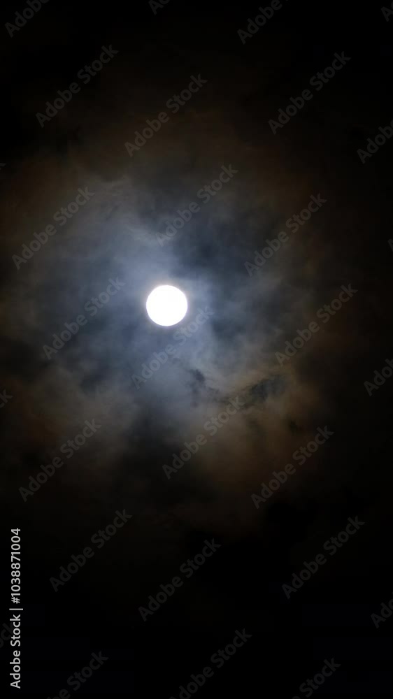 Vertical video of a full moon in the night sky with clouds Vertical video of a full moon in the night sky with clouds