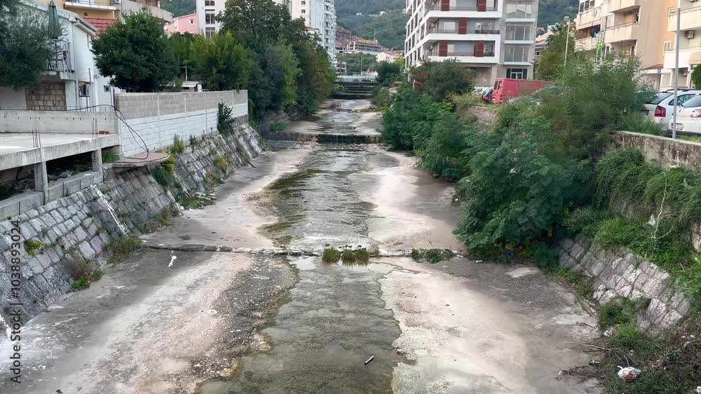 Urban Drought Affected Riverbed of Grdevica River in Budva Surrounded by Residential Buildings During October Urban Drought Affected Riverbed of Grdevica River in Budva Surrounded by Residential Buildings During October