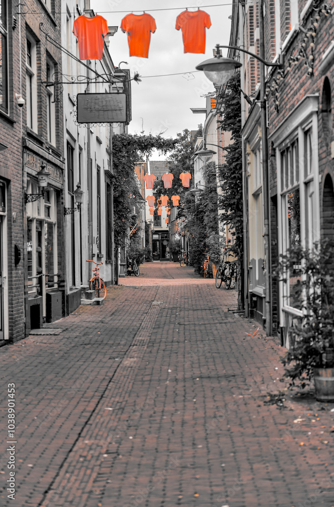 Obraz premium Arnhem, Netherlands - August 1, 2024: An old town street in Arnhem with an emphasis on the color orange, Netherlands 