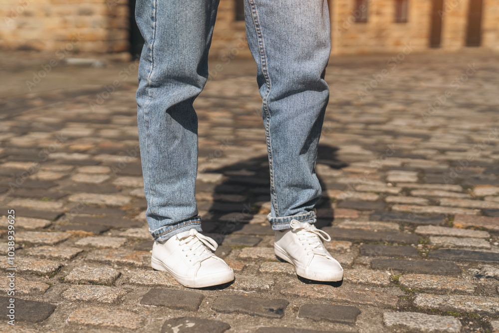 Casual street style captured on cobblestone pavement in warm sunlight during a late afternoon outing Casual street style captured on cobblestone pavement in warm sunlight during a late afternoon outing
