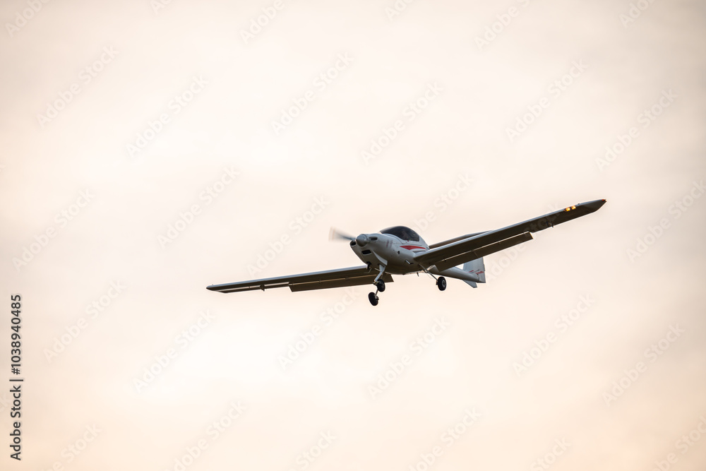 Small plane flying with sunset light in a blue sky. Light plane. Small plane flying with sunset light in a blue sky. Light plane.