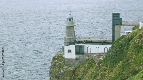 Santa Catalina Lighthouse with sea on the background, Lekeitio, Spain photo