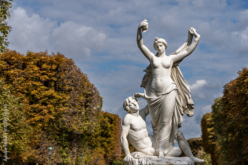 Standing topless woman with sitting man white stone statue in Paris Standing topless woman with sitting man white stone statue in Paris