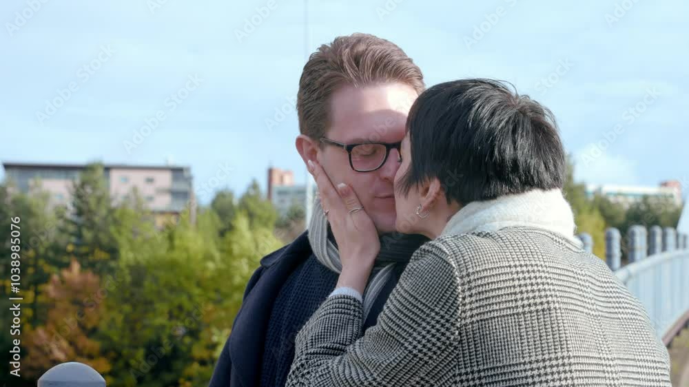 A tender moment shared between two lovers in an autumn park on a sunny afternoon A tender moment shared between two lovers in an autumn park on a sunny afternoon