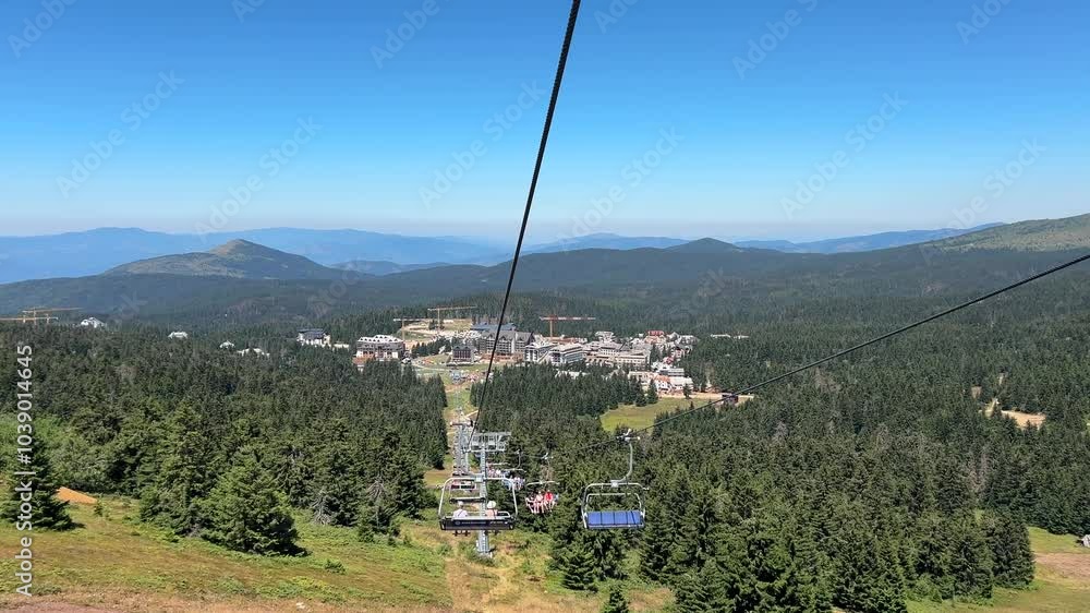 View from the cable car to the forest and mountains on a bright day View from the cable car to the forest and mountains on a bright day