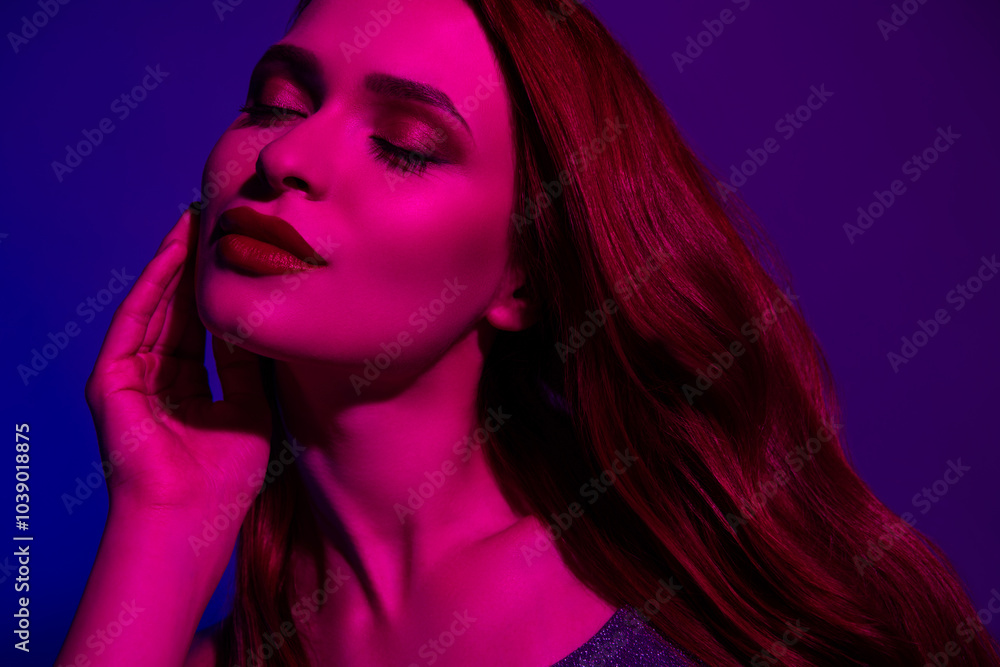 Photo of dreamy lovely gorgeous girl touch face isolated on neon ultraviolet dark light background Photo of dreamy lovely gorgeous girl touch face isolated on neon ultraviolet dark light background