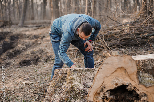 A Man Engaged in Woodworking in a Serene Forest Setting