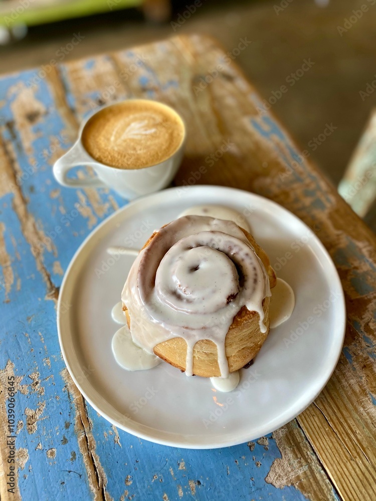 cinnamon roll and a hot coffee cinnamon roll and a hot coffee