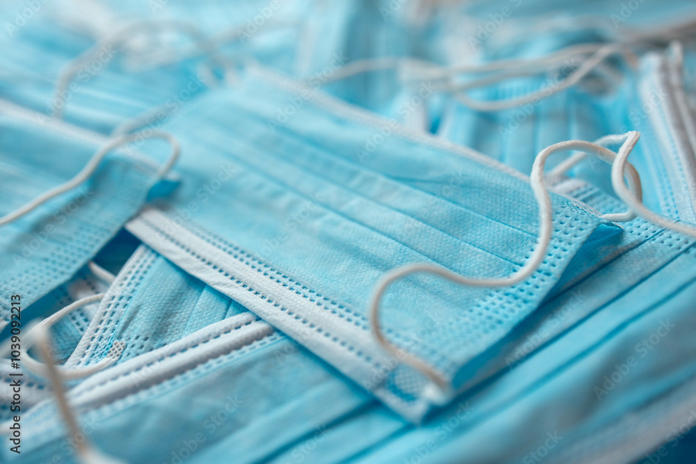 Many sterile medical blue disposable masks. Stack of new medical masks organized.