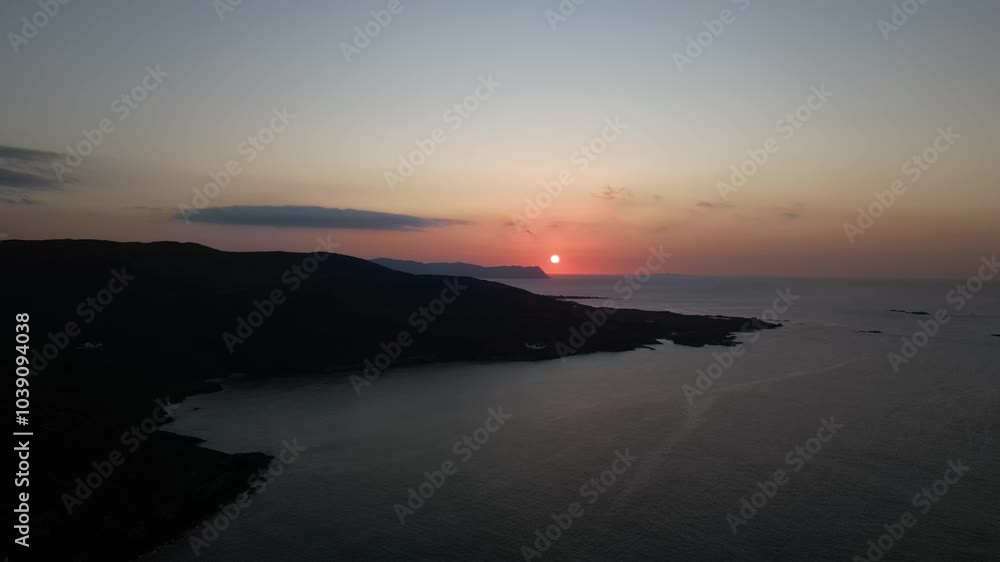 Aerial video of a sunset falling on the coastline of Ireland UK Aerial video of a sunset falling on the coastline of Ireland UK