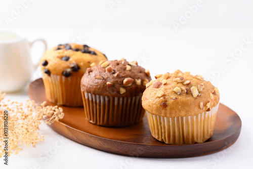 Vanilla almond muffin, Chocolate almond muffin and Vanilla chocolate chips muffin on wooden plate