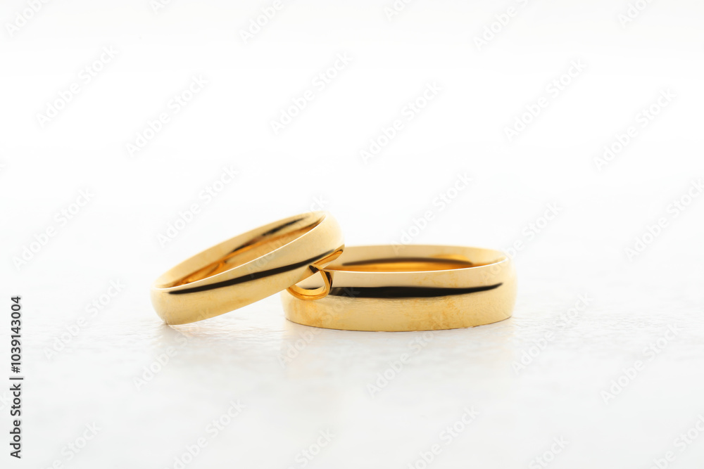 Beautiful golden wedding ring on white table Beautiful golden wedding ring on white table