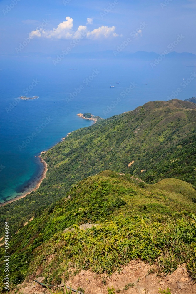 A Panoramic View of Rugged Coastline and Lush Green Hills A Panoramic View of Rugged Coastline and Lush Green Hills