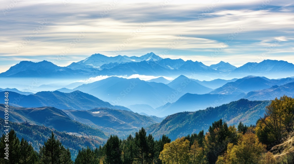 Obraz premium Serene mountain landscape with layered peaks and autumn foliage.