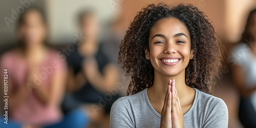 Young woman smiling while practicing yoga with group