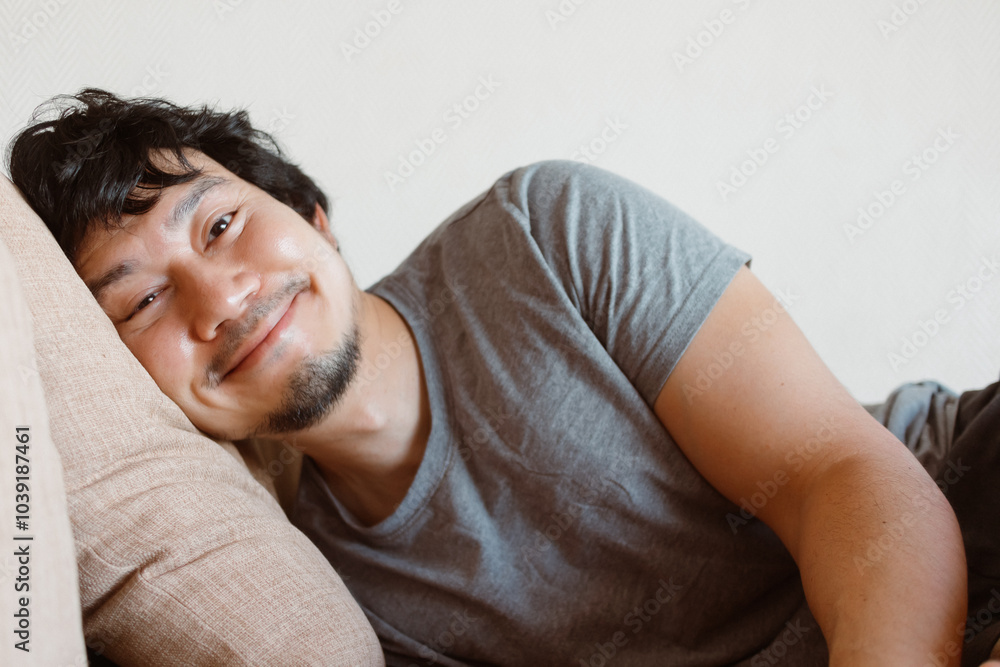 Happy smile face asian man enjoy resting on the sofa with pillow. Happy smile face asian man enjoy resting on the sofa with pillow.