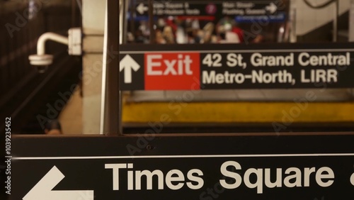 New York subway station interior, underground metropolitan platform. United States public metro transportation. Railway hub, passenger traffic junction. Text on sign Times Square, Grand Central, 42 St