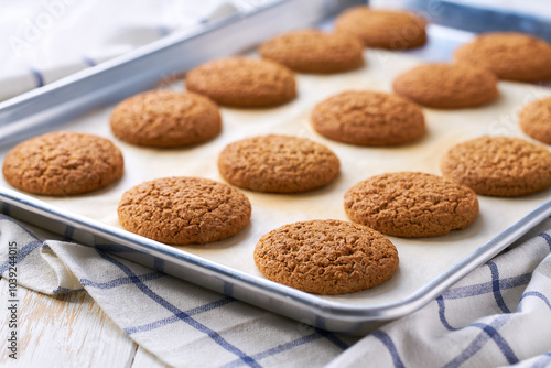 Close up of baking tray with low-calories oatmeal cookies.