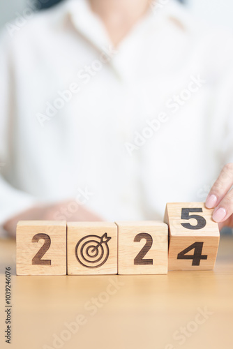 2024 year change to 2025 year block with dartboard icon. Goal, Target, Resolution, strategy, plan, Action, mission, motivation, and New Year start concepts photo