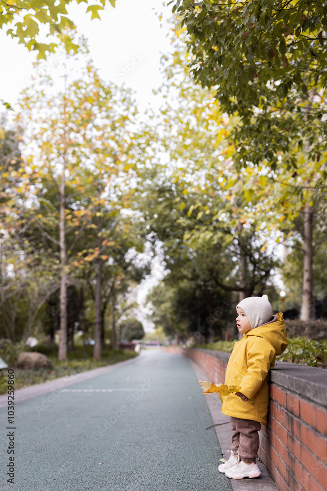 Cute caucasian baby girl one year old smiling during autumnal walk outdoor. Happy healthy kid with smiley face enjoying life and fall season Cute caucasian baby girl one year old smiling during autumnal walk outdoor. Happy healthy kid with smiley face enjoying life and fall season