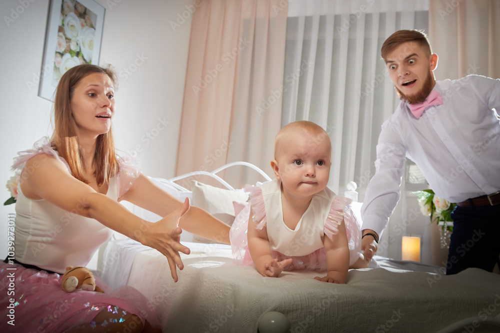 A family shares a joyful moment with their baby girl playing with a toy in a cozy, beautifully decorated room A family shares a joyful moment with their baby girl playing with a toy in a cozy, beautifully decorated room