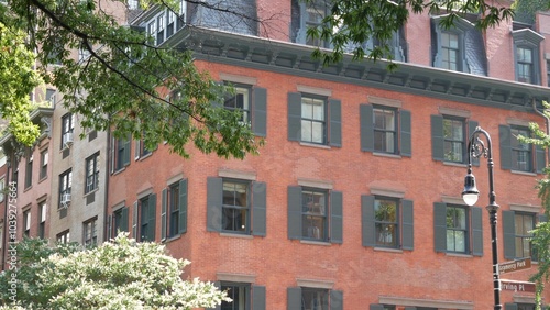 New York City classic building architecture. Urban residential house exterior. USA real estate property. Typical red brick facade, window shutters and lantern. Irving Pl, Gramercy, Manhattan Midtown. photo