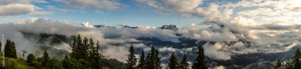 Panorama morning view of Alpien tops with broken clouds, blue sky and early sun rays, way to top Panorama morning view of Alpien tops with broken clouds, blue sky and early sun rays, way to top