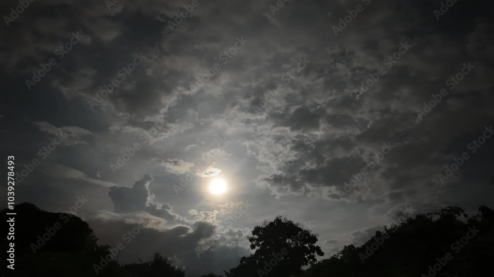 Timelapse of a full moon with clouds covering a large forest. Timelapse of a full moon with clouds covering a large forest.