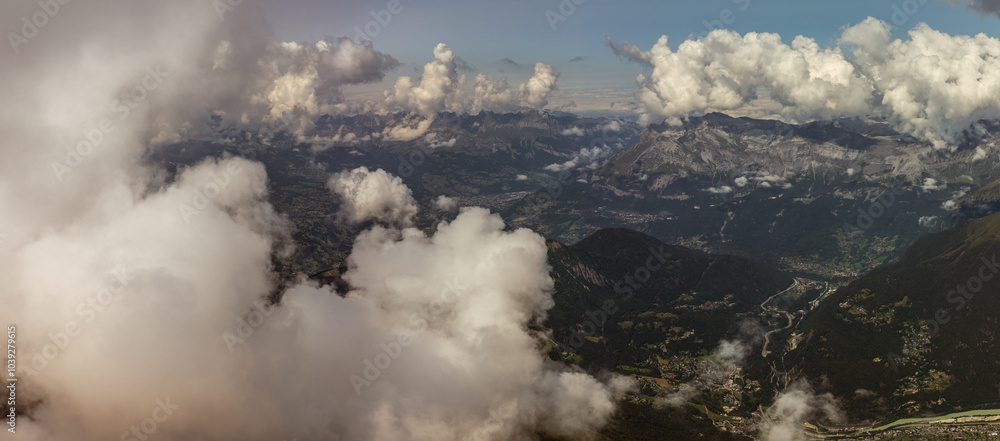 Panorama top view behind rock through clouds on valley under Mont Blanc from france normal way to top Panorama top view behind rock through clouds on valley under Mont Blanc from france normal way to top
