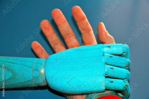 Robot hand winning against human hand. Arm wrestle . photo