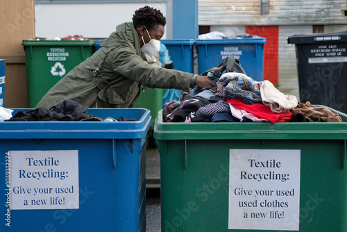 A person dropping off old clothes at a recycling center, encouraging textile recycling