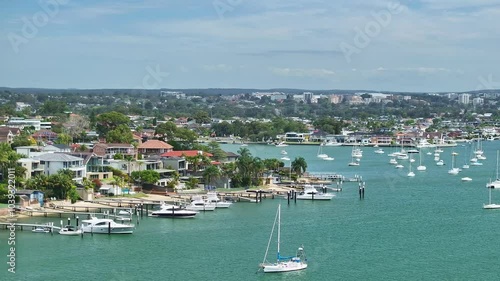 Overhead yachts and motor boats at Sans Souci with luxury houses beyond photo