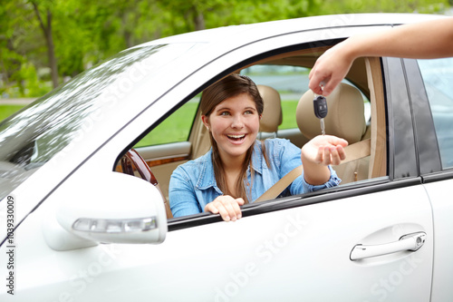 Excited girl, car or surprise with keys for license, asset or vehicle privileges in neighborhood. Young, female person or driver with smile by window for transport service, commute or motor ownership photo