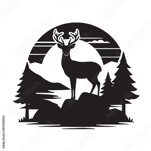 Silhouette of a deer standing on a rock with mountains in the background. photo