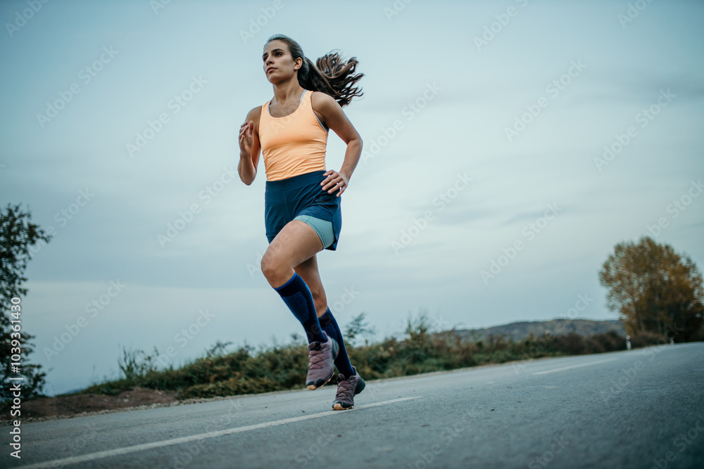 Shot of a young beautiful woman training for a marathon outdoors Shot of a young beautiful woman training for a marathon outdoors