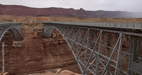 Navajo Bridge Arizona traffic endangered Condors birds. Upstream from Grand Canyon. Wide steel arch spanning steep canyon walls . Home to endangered California Condor vulture. Largest bird USA.