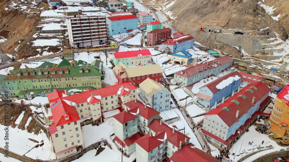 Colorful buildings with vibrant roofs in a snowy mountain town in Sewell, Chile, aerial view Colorful buildings with vibrant roofs in a snowy mountain town in Sewell, Chile, aerial view