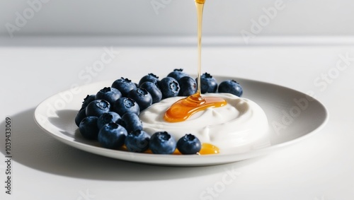 A spoonful of yogurt topped with blueberries and a drizzle of honey. photo