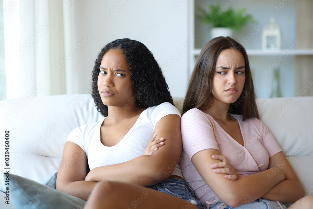 Angry interracial friends ignoring each other Angry interracial friends ignoring each other