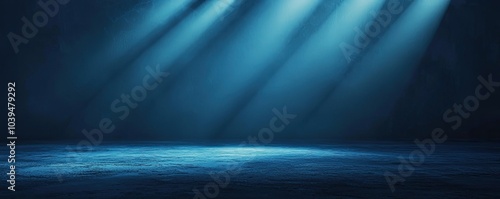 Abstract background of dark blue with light rays and mist, spotlight on an asphalt floor for display products. Dark scene with reflections from the water surface