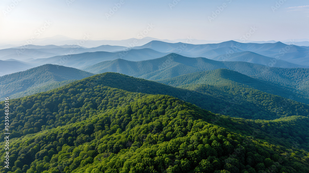 Fototapeta premium scenic aerial view of lush green mountains, showcasing rolling hills and serene landscape under clear sky. beauty of nature is truly captivating