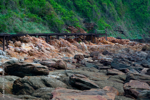 A wooden bridge on the edge of a rocky mountainside