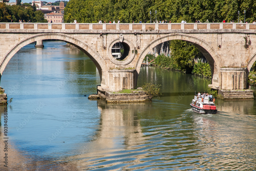 Naklejka premium Old bridge over the Tiber River with water reflection in Rome, Italy
