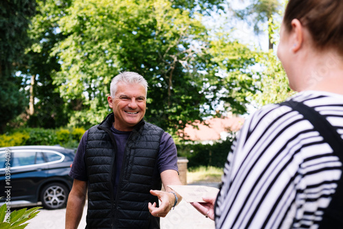Smiling workman getting paid through paycheck